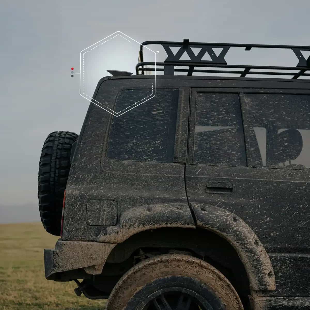 Rugged off-road vehicle with satellite antenna in dusty terrain.