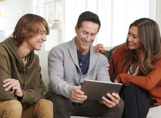 family looking at tablet
