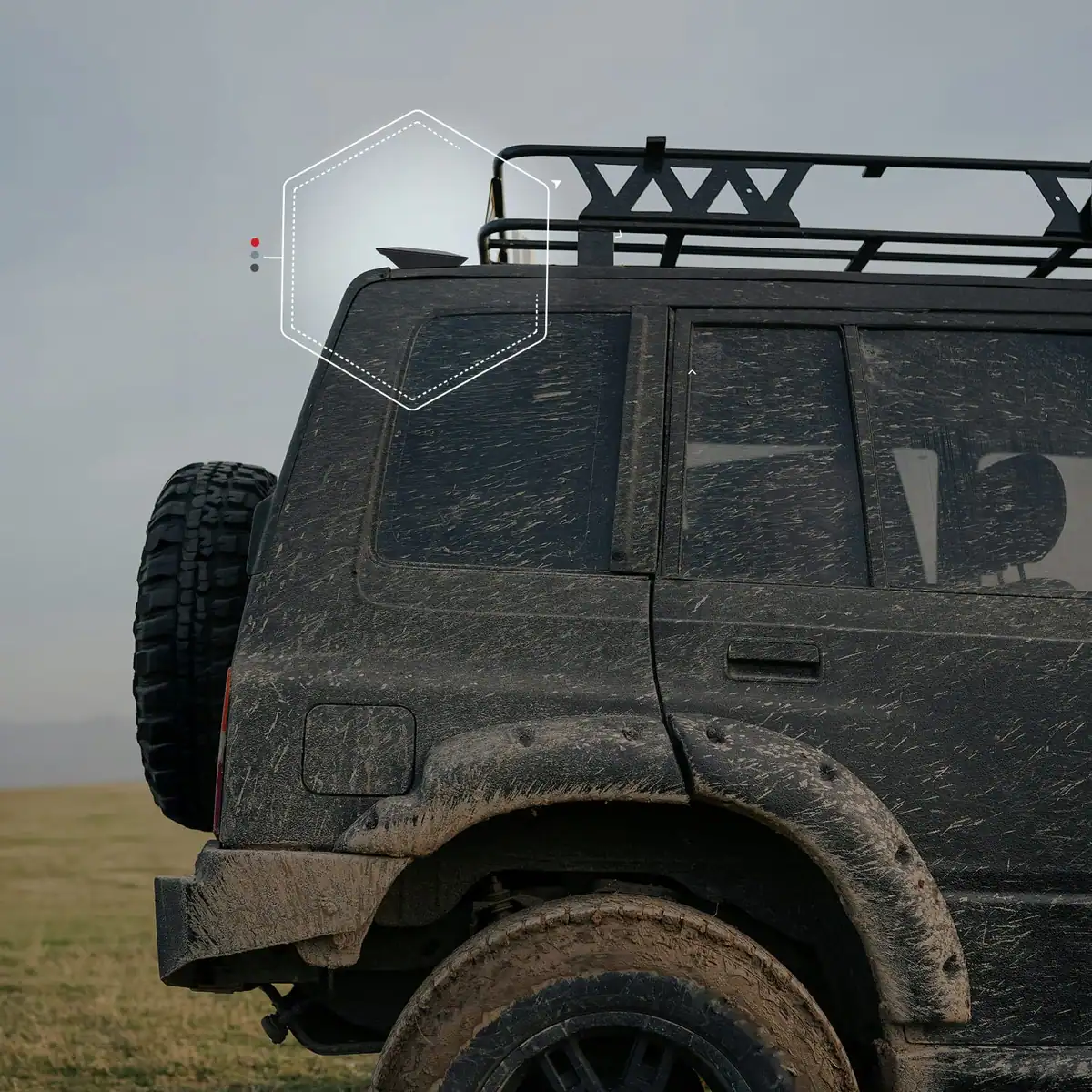 Rugged off-road vehicle with satellite antenna in dusty terrain.