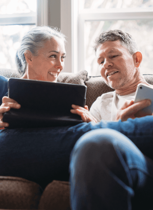 Couple at home enjoying great call phone signal at home thanks to weBoost