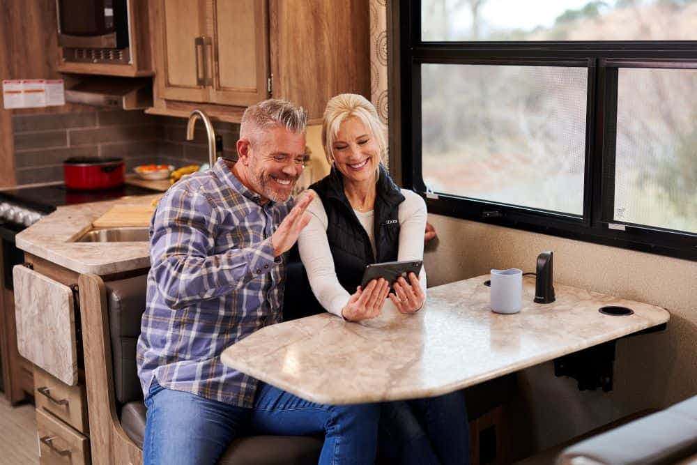 couple sits in RV and makes videocall - weBoost Drive Reach RV