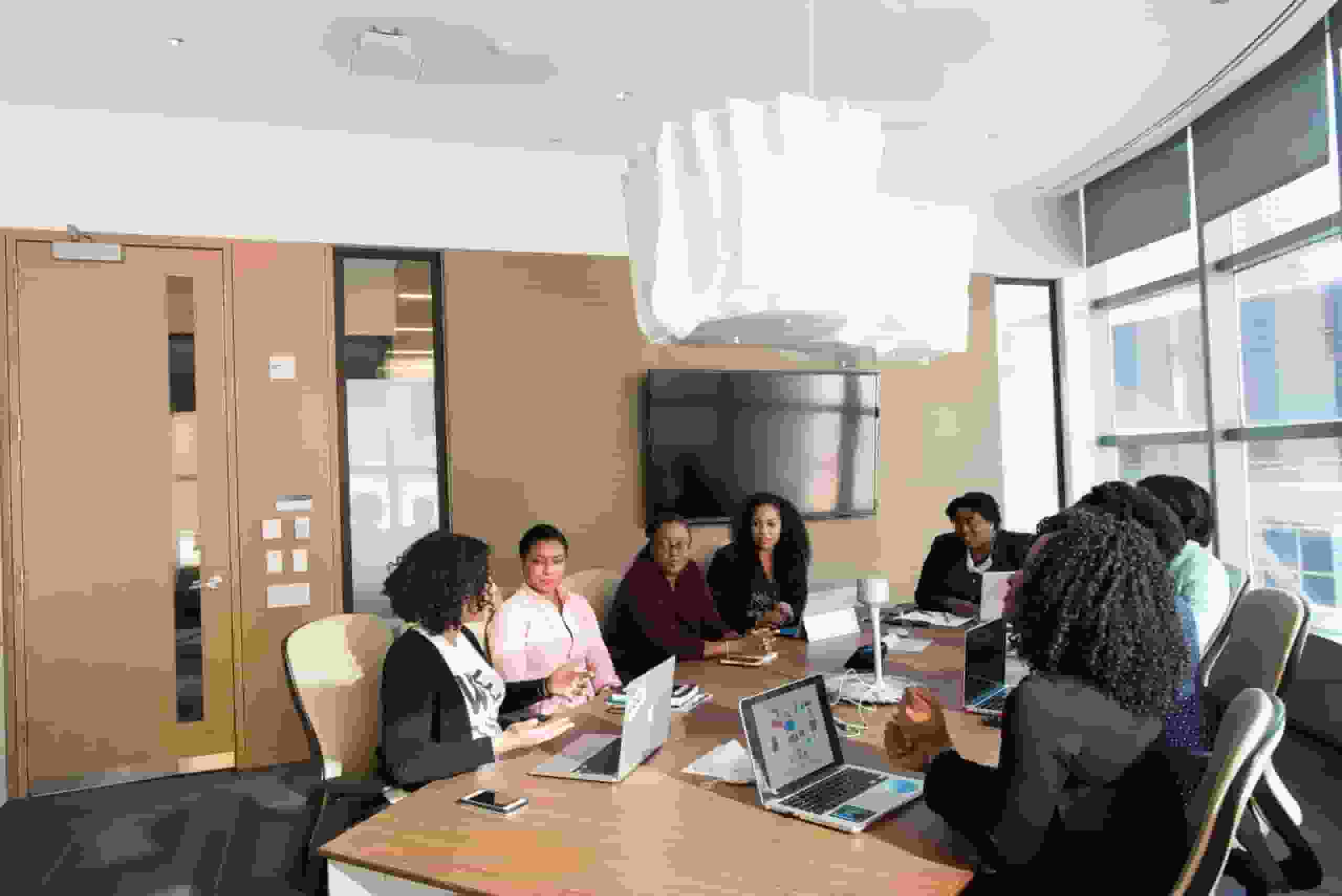 weBoost vs WilsonPro. Employees gather in a conference room.